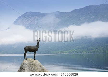 BOHINJ LAKE, SLOVENIA - JULY 28, 2019: Bronze statue of the legendary deer Zlatorog (The Golden Horn)