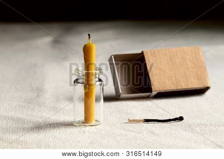In A Dark Room On The Table Is An Extinct Candle. Empty A Matchbox And Last Match Burned To Symboliz