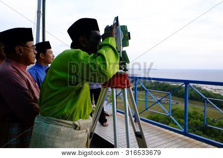 Labuan, Malaysia - Jun 27, 2014 : Muslim Looking Through The Theodolite To Observe Moon To Mark The 