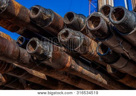 Oil Drill Pipe. Rusty Drill Pipes Were Drilled In The Well Section. Downhole Drilling Rig. Laying Th