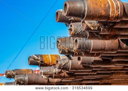 Oil Drill Pipe. Rusty Drill Pipes Were Drilled In The Well Section. Downhole Drilling Rig. Laying Th