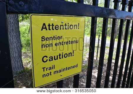 Yellow Caution Trail Not Maintained Sign In English And French