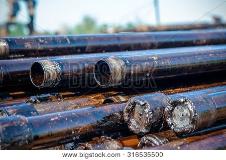Oil Drill Pipe. Rusty Drill Pipes Were Drilled In The Well Section. Downhole Drilling Rig. Laying Th