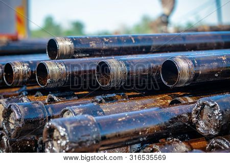 Oil Drill Pipe. Rusty Drill Pipes Were Drilled In The Well Section. Downhole Drilling Rig. Laying Th