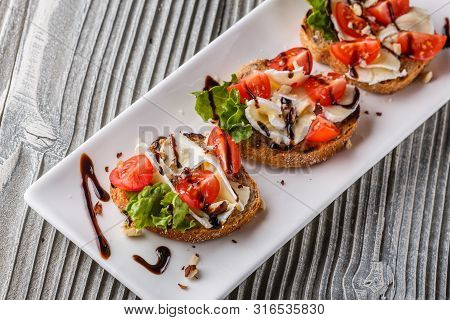 Bruschetta With Tomatoes, Lettuce, Camambert, Balsamic Vinegar