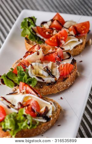 Bruschetta With Tomatoes, Lettuce, Camambert, Balsamic Vinegar