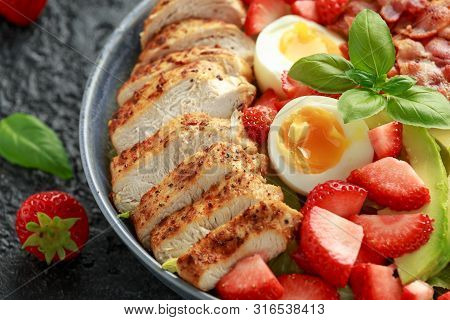 Chicken Cobb Salad With Strawberries, Bacon, Avocado And Boiled Eggs.