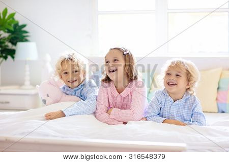 Kids Play In Bed. Children At Home.