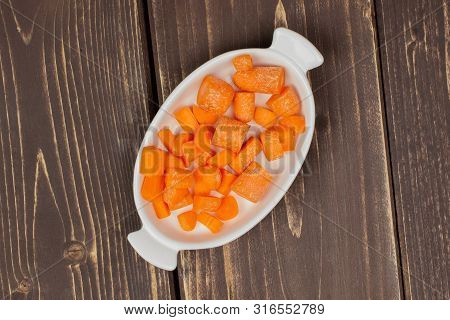 Lot Of Pieces Of Stale  Orange Stale Baby Carrot Baby In A Wooden Bowl Flatlay Isolated On Brown Woo