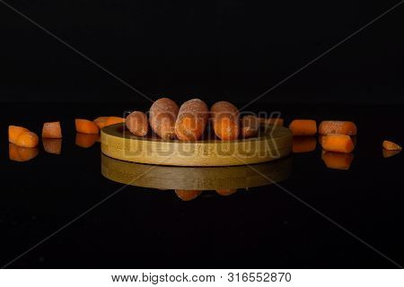 Group Of Five Whole Lot Of Pieces Of Stale  Orange Stale Baby Carrot Baby On Bamboo Plate Isolated O