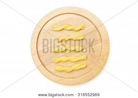 Group Of Five Whole Raw Pasta Gemelli On Bamboo Plate Flatlay Isolated On White Background