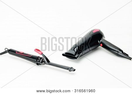 Electrical Hair Iron And Dryer For Household On The White Mat Background With Copy Space