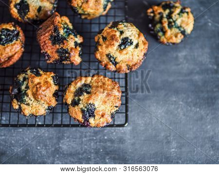 Homemade Vegan Blueberry Muffins On Cooling Rack. Vegetarian Egg-free Muffins On Dark Background. To