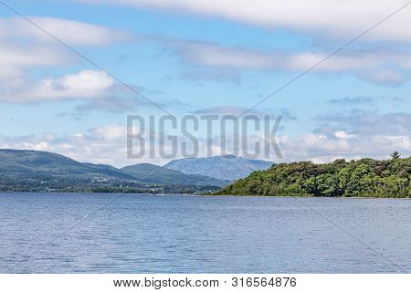 Lough Corrib With Forest And Conerama Mountains In Background