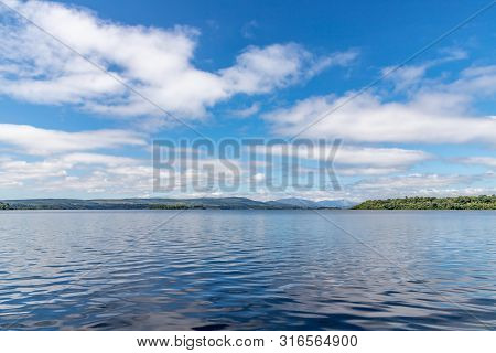 Lough Corrib With Forest And Conerama Mountains In Background