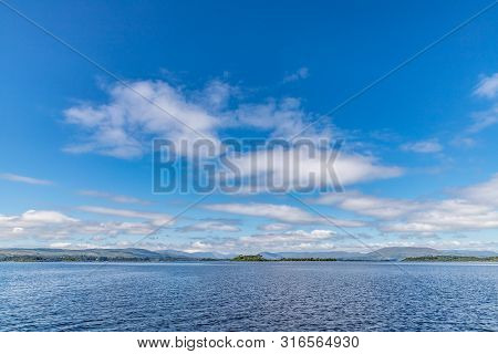Lough Corrib With Forest And Conerama Mountains In Background