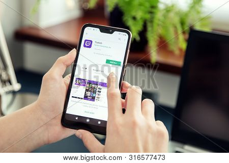 Wroclaw, Poland - July 31th, 2019: Woman Installs Netflix Application On The Xiaomi A2 Smartphone. T