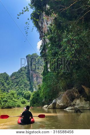 Canoe On River Through The Jungle In Thailand