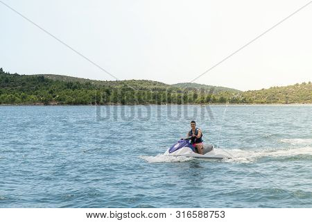 Young Man On Jet Ski, Tropical Ocean, Vacation Concept