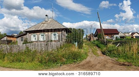 Panoramic View Of The Village Street With Old And New Wooden Houses. Village Of Visim, Sverdlovsk Re