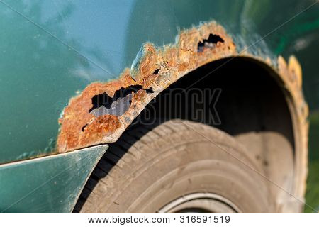 Rusty Right Wing Of Car With Corrosive Defect. Corrosion And Rust