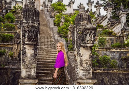 Young Woman Tourist On Background Of Three Stone Ladders In Beautiful Pura Lempuyang Luhur Temple. S