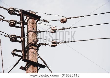 Electric Wire And Pole With White Sky