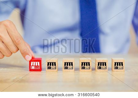Franchise Business Concept , Businessman Hand Choose Wood Blog With Franchise Marketing.