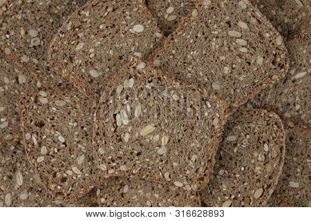 Slices Of Stacked Brown Bread. Food Background Or Texture
