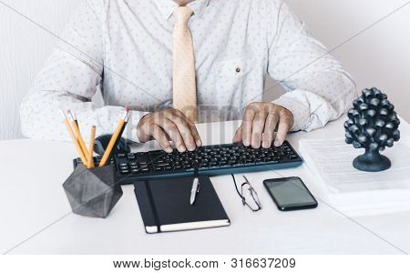 Close-up Of Hands Middle-aged Man In White Shirt And Yellow Tie Typing On Keyboard Laptop Computer, 