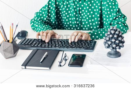 Close-up Of Hands Middle-aged Woman In Green Blouse Typing On Keyboard Laptop Computer, Concrete Hol