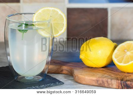 Home Made Lemonade. Refreshing Healthy Glass Of Cold Water With Lemon. Fresh Lemons And Mint With Au