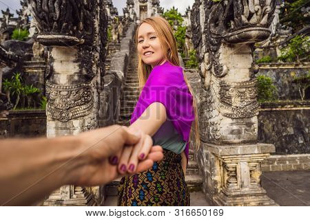 Follow Me Photo. Young Woman Tourist On Background Of Three Stone Ladders In Beautiful Pura Lempuyan