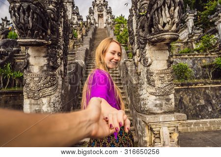 Follow Me Photo. Young Woman Tourist On Background Of Three Stone Ladders In Beautiful Pura Lempuyan