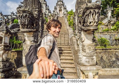 Follow Me Photo. Young Man Tourist On Background Of Three Stone Ladders In Beautiful Pura Lempuyang 