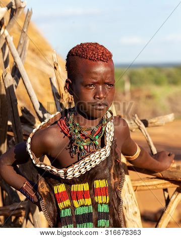Turmi, Omo River Valley, Ethiopia - May 10, 2019: Portrait Of A Hamar Woman In Village. The Hamer Ar