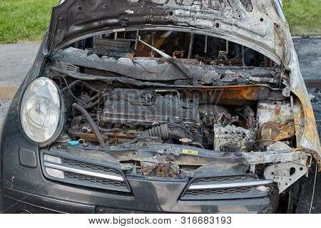 Burnt Car After A Fire, Body Parts Burnt Door Handles And Cracked Glass, The Picture Is Not Pleasant