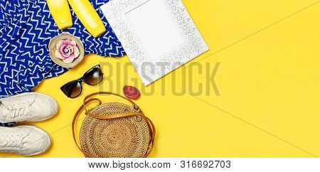 Female Summer Fashion Background. Clothes And Accessories On Yellow Background. Blue Dress, Round Ra