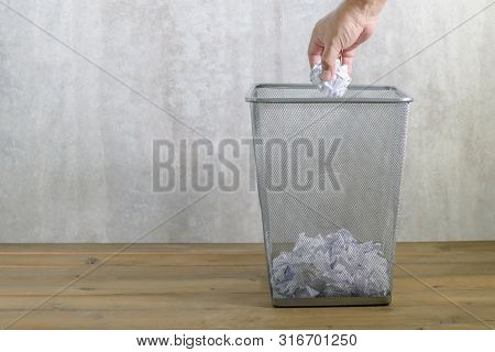 Hand Man Putting Crumpled Paper Into Metal Trash Can, Waste And Save Environmental Concept