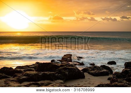 Seascape. Beach At Sunset. Bright Sunlight. Horizon Line. Beach With Rocks, Stones, Sand. Ocean With