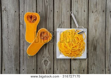 Overhead Top View Of Freshly Peeled Butternut Squash Noodles And Julienne Peeler