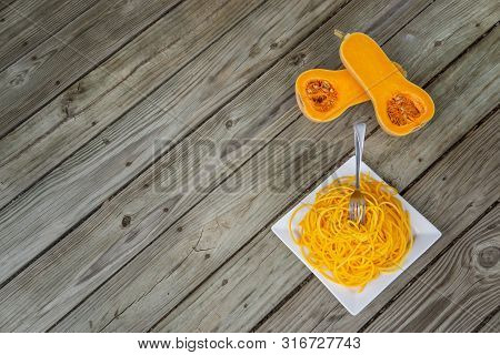 Top View Of Healthy Butternut Squash Noodles With Fork Stuck In Pasta