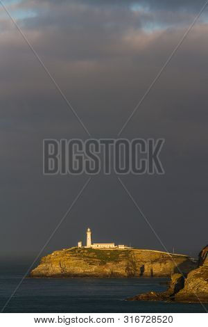 Lighthouse On Rocky Outcrop In Morning Light, Portrait