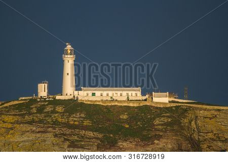 Lighthouse On Rocky Outcrop In Morning Light, Copyspace