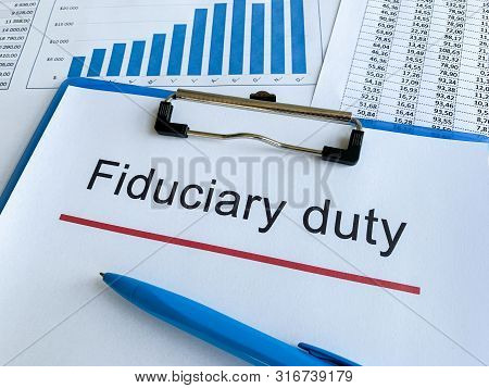 Paper With Text Fiduciary Duty On Wood Table.