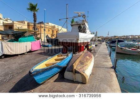 Traditional Fishing Boats Called Luzzu In The Bay Of The Village Marsaxlokk. Malta.