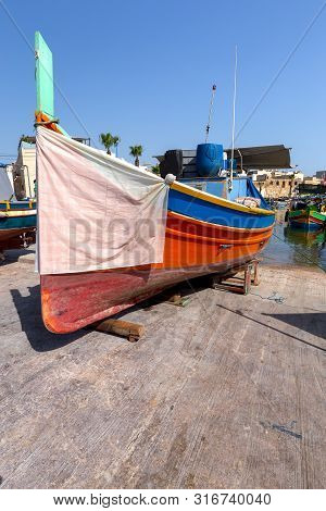 Traditional Fishing Boats Called Luzzu In The Bay Of The Village Marsaxlokk. Malta.