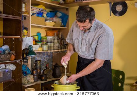 Professional Male Potter Preparing Ceramic Wares For Burning In Pottery Kiln With Milk - Old Russian