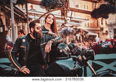 Beautiful Couple With Brutal Biker And His Sexy Gilfriend Are Chilling Near Cefeteria With Motorbike