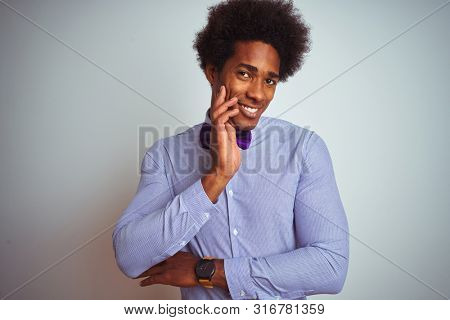 Afro business man wearing striped shirt and purple bow tie over isolated white background thinking looking tired and bored with depression problems with crossed arms.